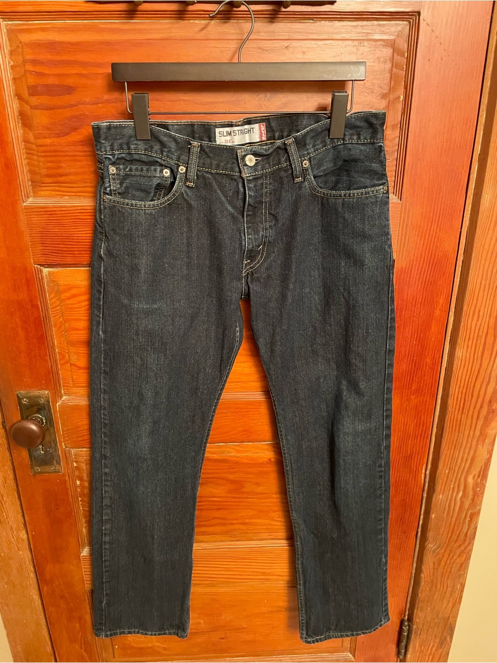 Levi's 514 Slim Straight jeans in a dark denim wash with a button closure.